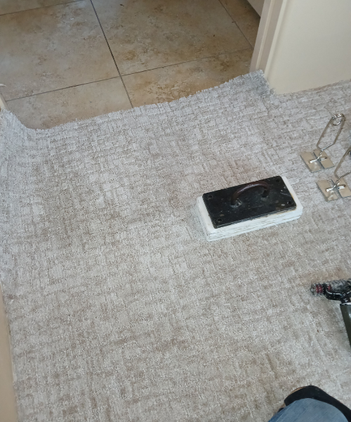 A bathroom with a tile floor and a phone on the floor